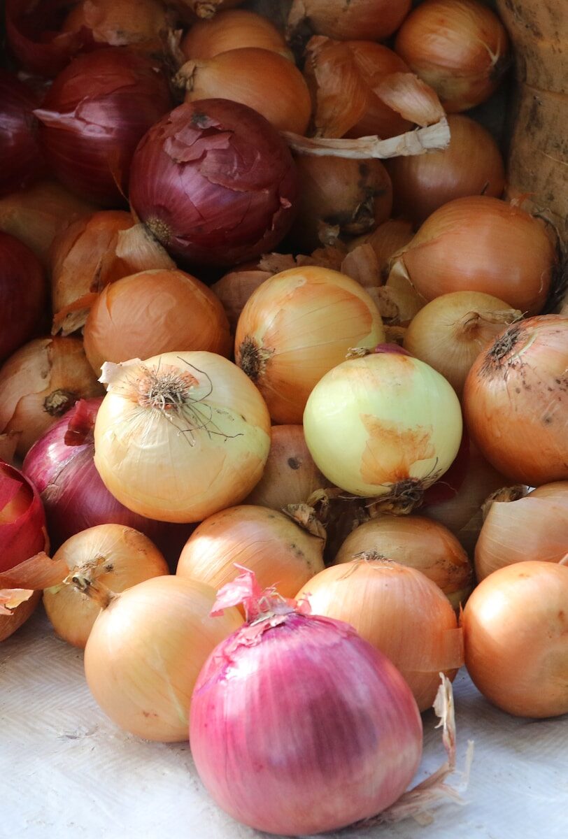 a pile of onions sitting on top of a table